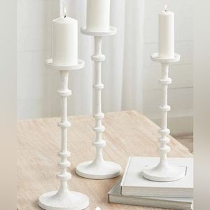 Mud Pie skinny metal candlesticks feature a white-washed finish.